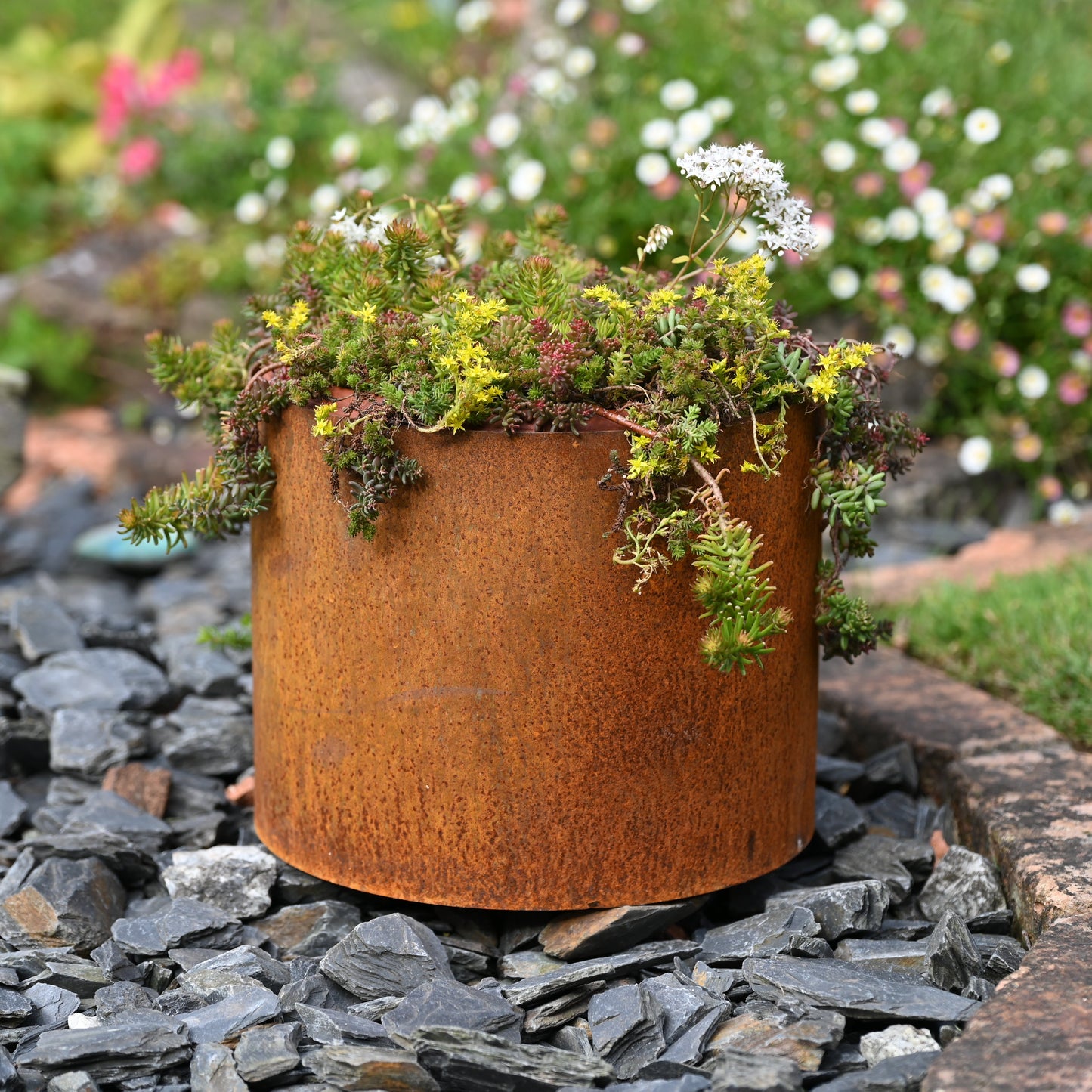 Rusty garden plant pot from SavageWorksUK with a weathered, textured surface suitable for outdoor planters.