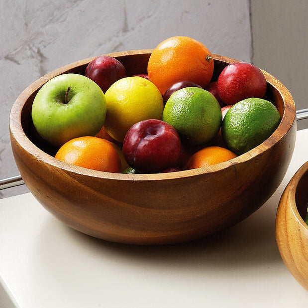 Orsina Kora Acacia wood fruit and salad bowl with a smooth, polished finish, ideal for serving fresh fruit and salads.