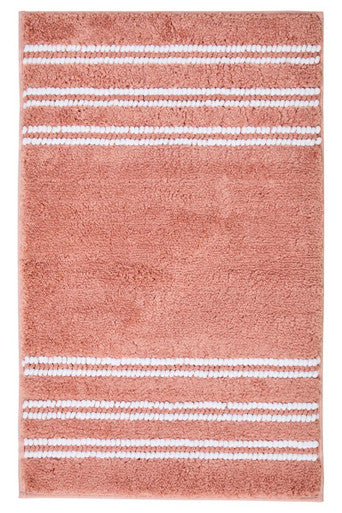 Dusky pink Soak large bath mat by Orsina, soft textured bathroom textile with non-slip backing, placed on a bathroom floor.