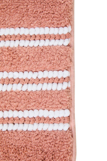 Large dusky pink bath mat from Orsina, soft bathroom textile with textured surface for comfort and style.