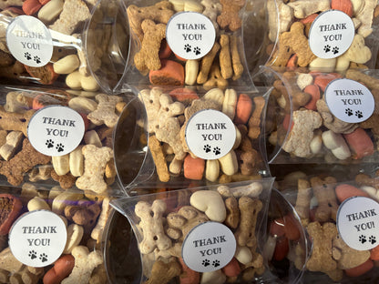 Assorted dog chocolate and biscuit treats in thank you gift boxes by The Bonnie Hound, displayed in colorful packaging
