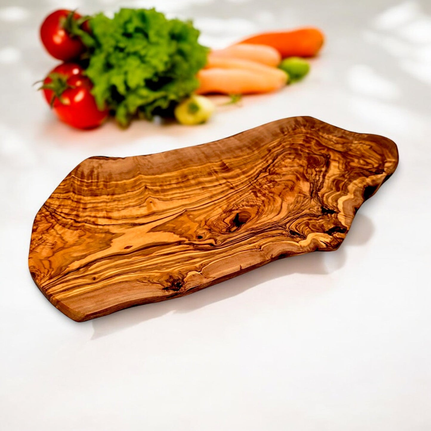 Large rustic olive wood charcuterie board with an irregular shape, handcrafted by OliveArt for serving cheese and appetizers.