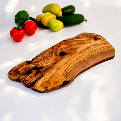 Large rustic olive wood charcuterie board with irregular shape, handcrafted by OliveArt, showcasing natural wood grain and craftsmanship.