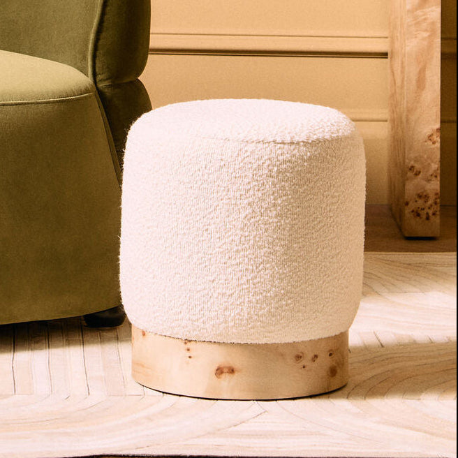 Orsina Mota burl wood and cream boucle round stool with modern design, featuring a wooden base and plush fabric upholstery.