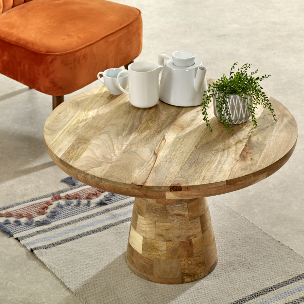 Solid wood mushroom-shaped coffee table from Surrey by InStock, featuring a natural finish and smooth round top.