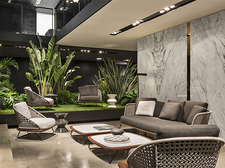 DC Concept Zarina outdoor sofa set with garden armchair, featuring modern cushions in an outdoor garden setting.