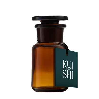 Amber glass apothecary jar used as bathroom decor, with a 50ml capacity, by Kuishi. Perfect for organizing small items.