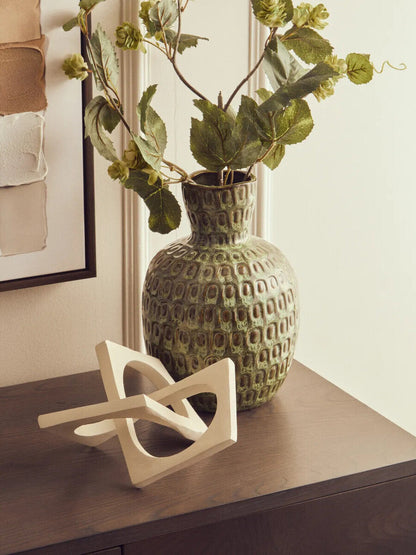 Large green textured ceramic vase by Orsina with a rounded shape and decorative surface, ideal for home decor.