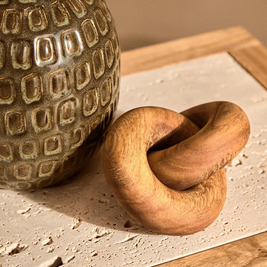Small brown wood knot sculpture from Orsina, featuring a natural wooden design perfect for home decor.