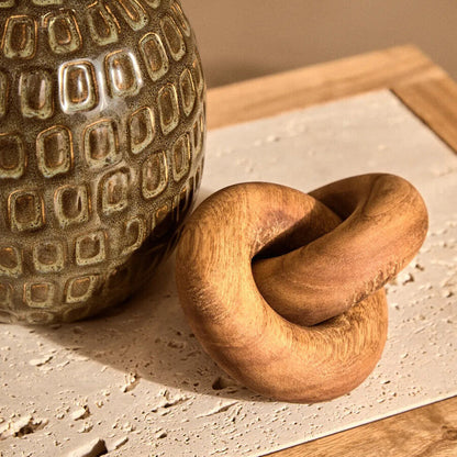 Small brown wood knot sculpture from Orsina, featuring a natural wooden design perfect for home decor.