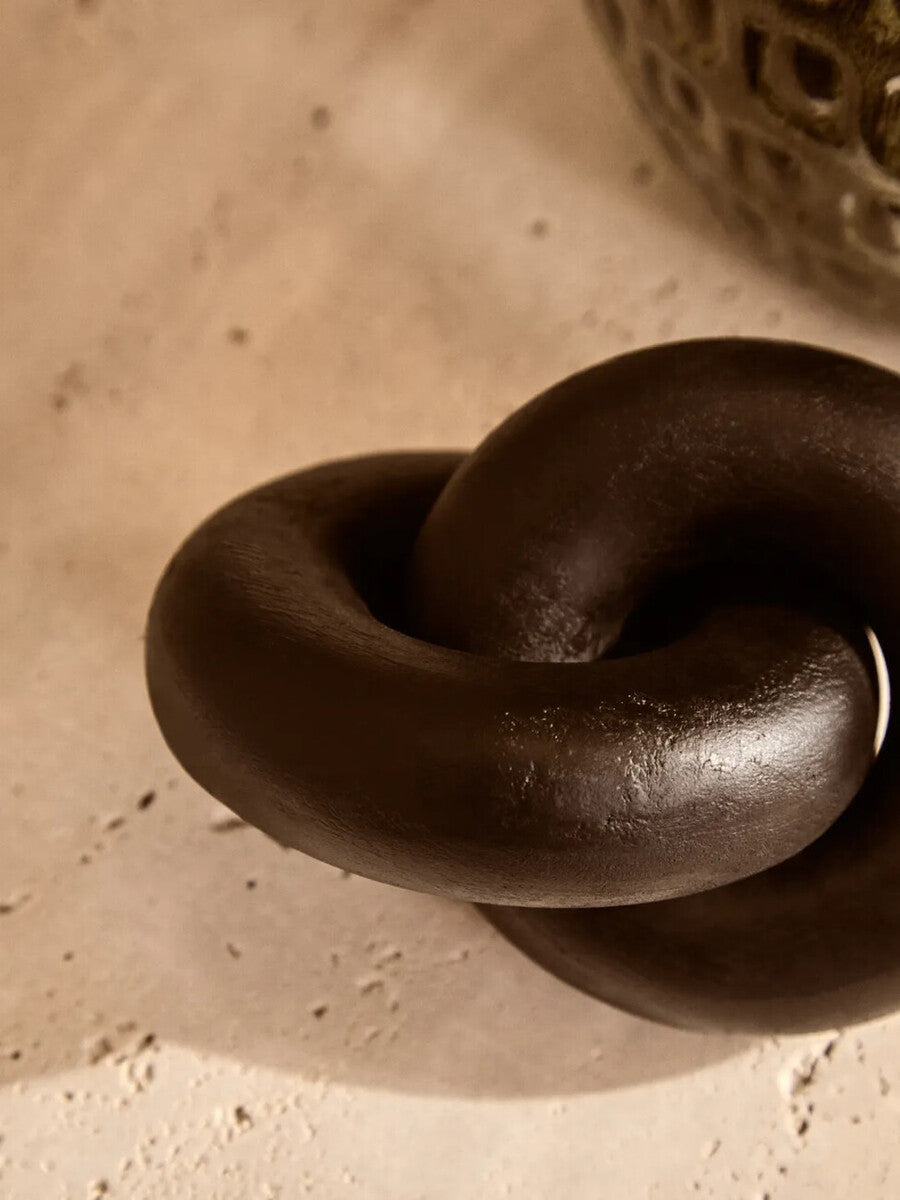 Black wood knot sculpture by Orsina, small decorative knot ornament made of dark polished wood, suitable for modern decor.