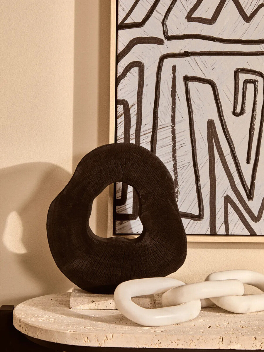 Orsina Tibor black mango wood sculpture with travertine base, modern decorative art piece for home or office.