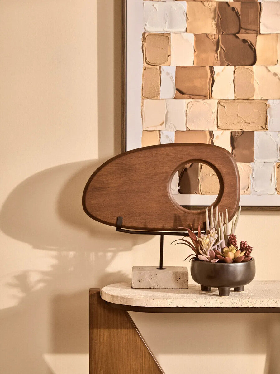 Westo natural wood horizontal sculpture with travertine base by Orsina, featuring sleek wooden design and elegant stone foundation.