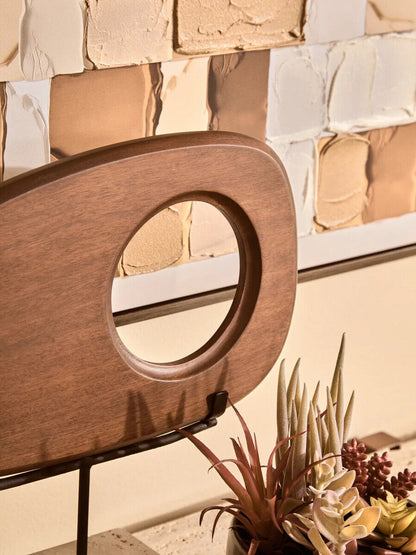 Westo natural wood horizontal sculpture with travertine base by Orsina, showcasing smooth wooden design on a stone foundation.