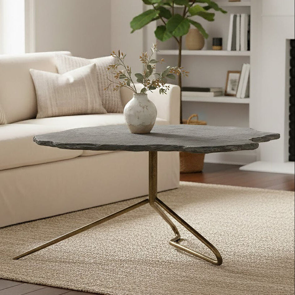 Grey stone top coffee table with tripod geometric base by Orsina, showcasing a modern and stylish living room centerpiece.