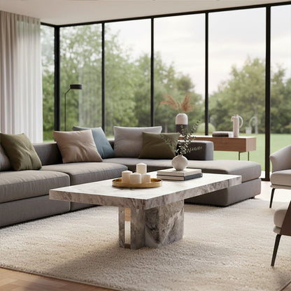 Grey marble top coffee table with pedestal base and silver metal trim by Orsina, modern living room centerpiece