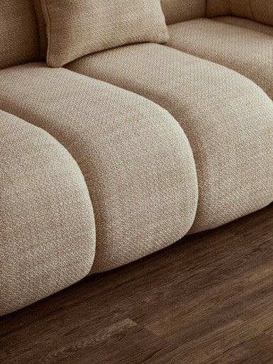 Cream linen 3-seater sofa with curved design by Orsina, featuring plush cushions and modern style for living room decor.