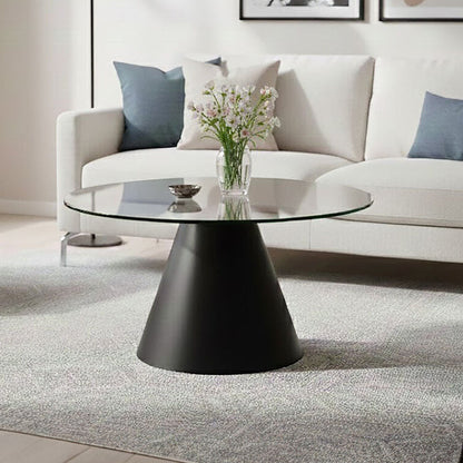 Clear glass round top coffee table with black conical metal base by Orsina, modern and sleek living room furniture.