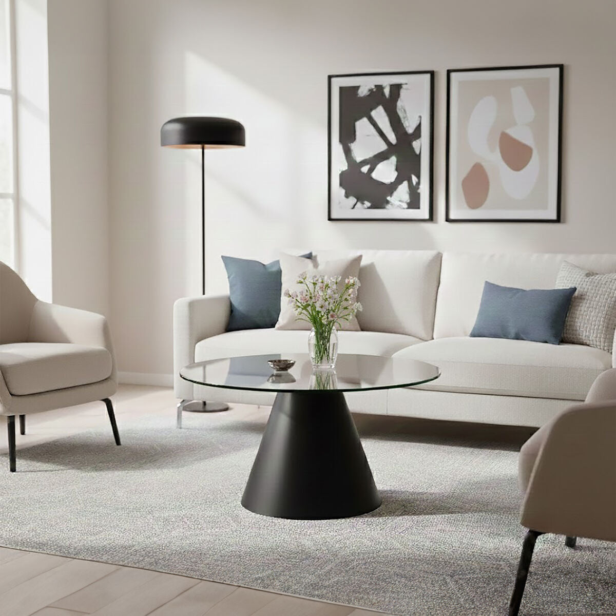Clear glass round top coffee table with black conical metal base by Orsina, modern and stylish living room furniture.