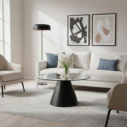 Clear glass round top coffee table with black conical metal base by Orsina, modern and stylish living room furniture.