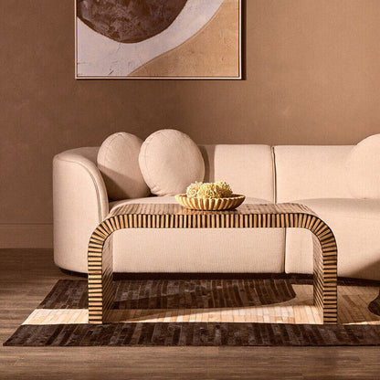 Natural finish curved coffee table by Orsina with striped bamboo inlay, showcasing smooth curves and textured bamboo details.