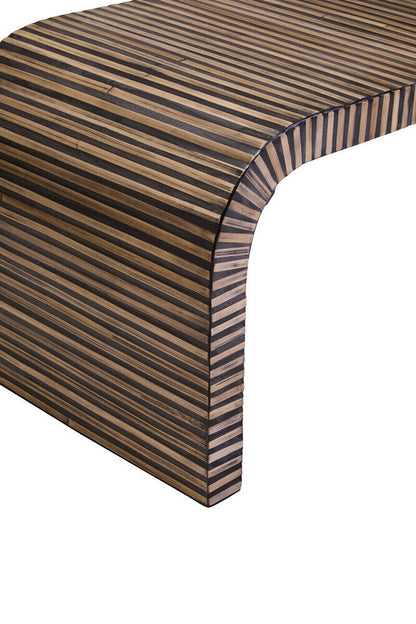 Natural finish curved coffee table by Orsina with striped bamboo inlay, showcasing smooth wood surface and elegant design.
