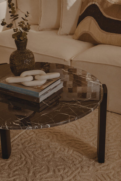 Black round marble top coffee table with black acacia wood legs, Palermo style by Orsina, modern living room furniture.