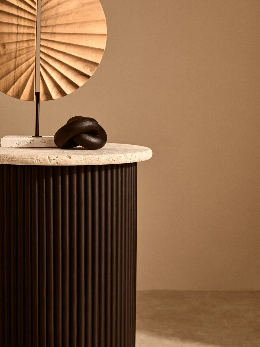 Cream polished travertine side table with ridged black acacia wood cylindrical base, designed by Orsina Walton.