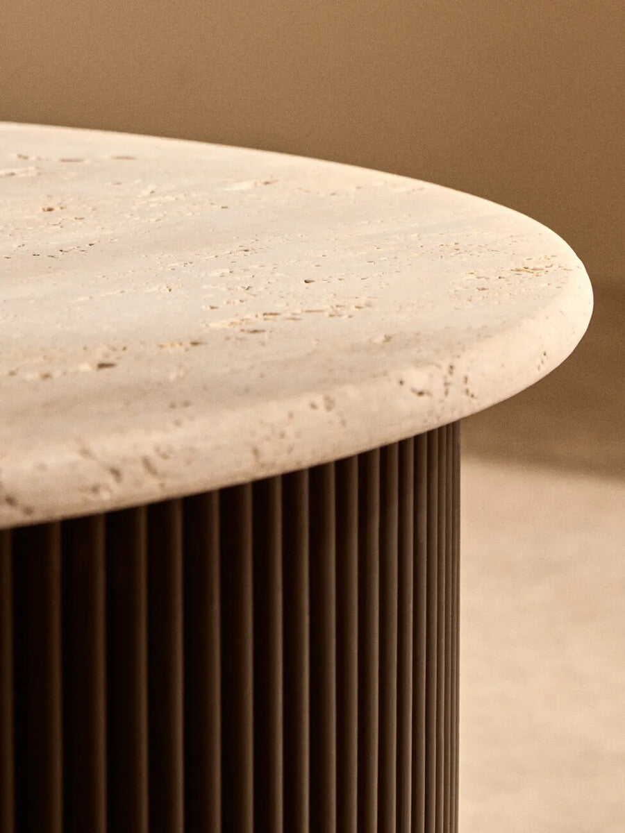 Cream polished travertine top coffee table with ridged black acacia wood drum base by Orsina.