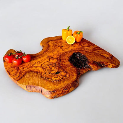 Large rustic olive wood charcuterie board with irregular shape, handcrafted by OliveArt, showcasing natural wood grain and artisanal craftsmanship.