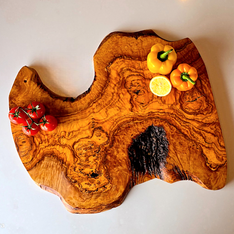OliveArt handcrafted large rustic olive wood charcuterie board with irregular shape and natural wood grain detail.
