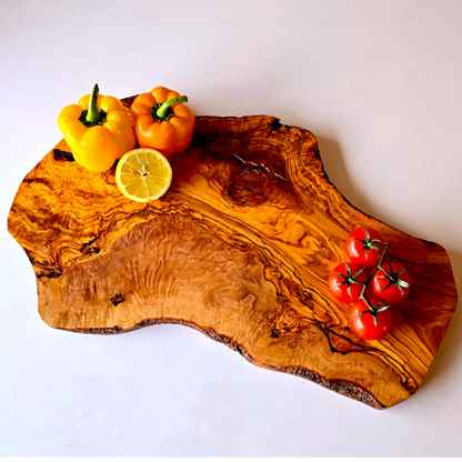 OliveArt large rustic handcrafted olive wood charcuterie board with an irregular shape and natural wood grain detail.