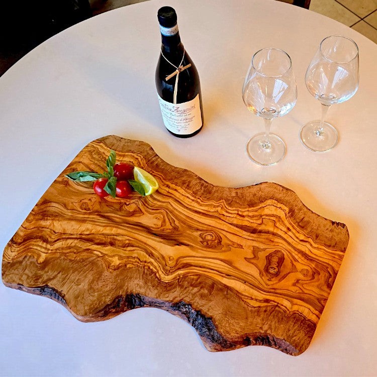 Large rustic olive wood charcuterie board by OliveArt, handcrafted with an irregular shape and natural wood grain details.