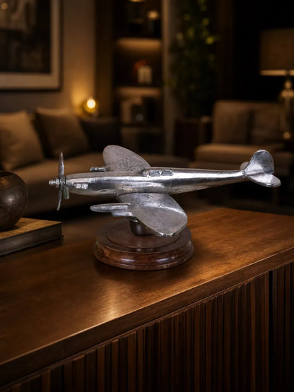 Vintage Spitfire model ornament by Maravi featuring a metal airplane on a wooden base, ideal for display or collection.