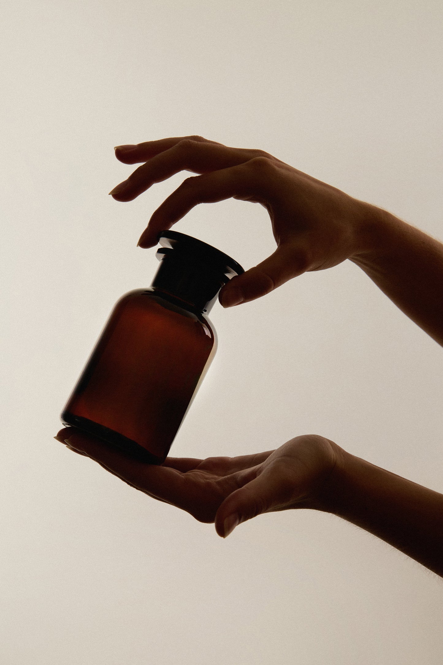 Amber glass apothecary jar from Kuishi, used as bathroom decor, featuring a vintage-style container with a lid.