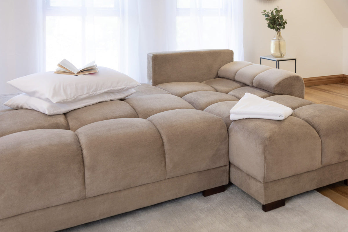 Beige Azzuro universal corner sofabed in plush velvet with a convertible design and built-in storage, shown from the right-hand side.