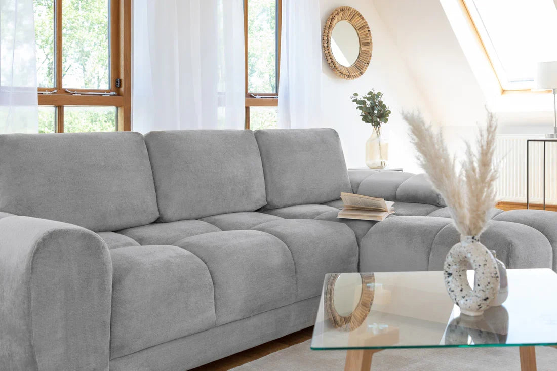 Azzuro universal corner sofa bed in plush grey velvet with convertible design and built-in storage, shown in a modern living room setting.