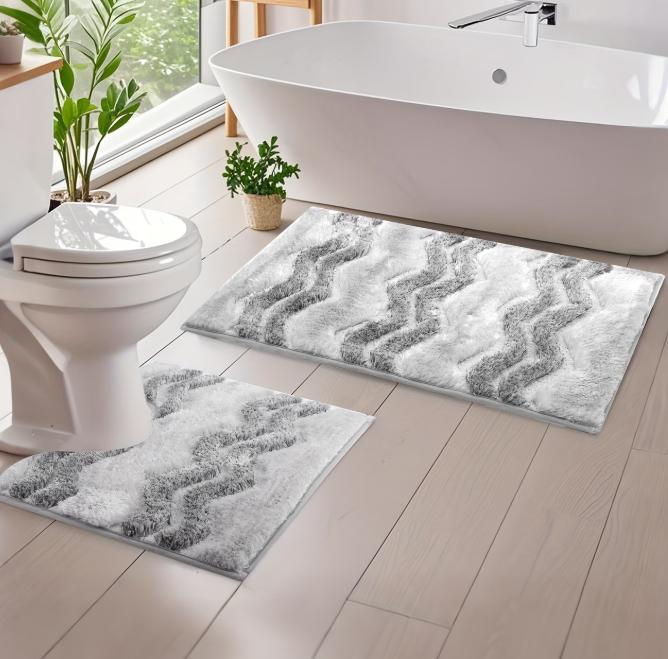 Two gray luxury chenille bathroom rugs from DEPOT with textured, ultra-soft, and highly absorbent fabric on a bathroom floor.