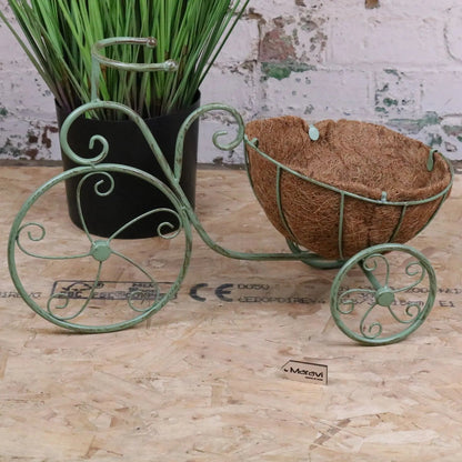 Vintage green metal bike garden planter by Maravi, featuring a charming bicycle design perfect for outdoor garden decor.