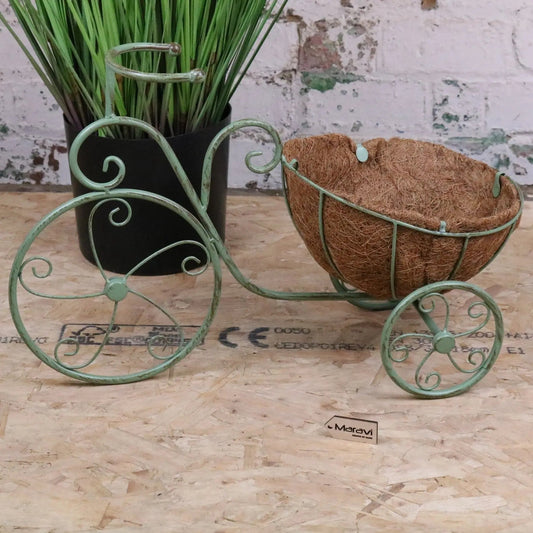 Vintage green metal bike garden planter by Maravi, featuring a charming bicycle design perfect for outdoor garden decor.