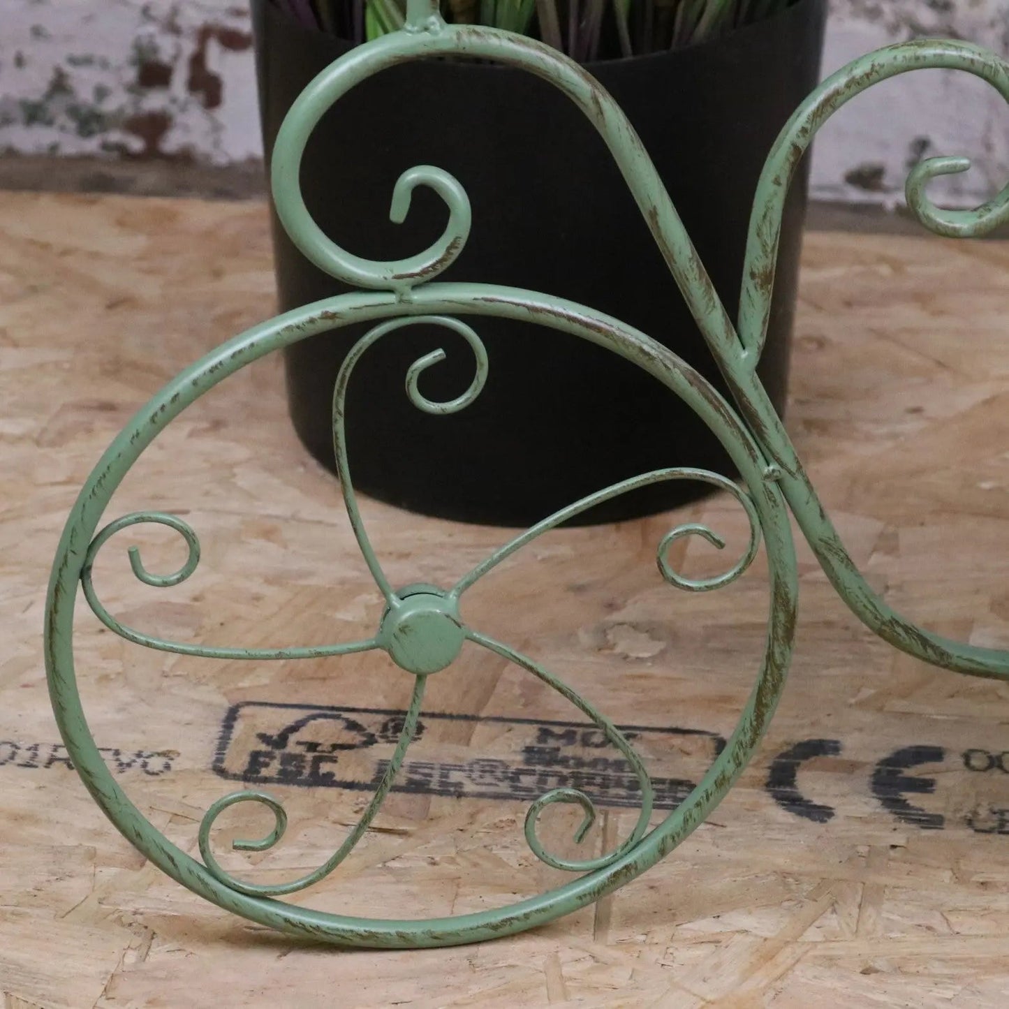 Vintage green metal bike garden planter by Maravi, featuring a charming bike-shaped design for outdoor garden decor.