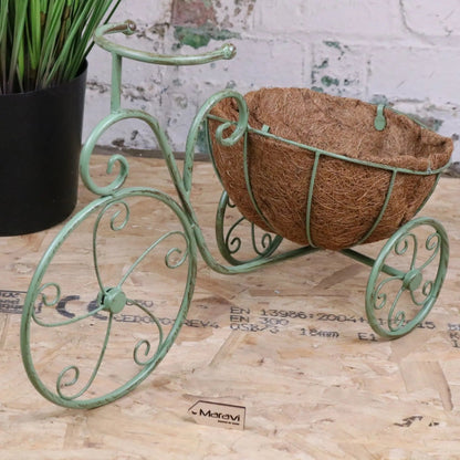 Vintage green metal bike garden planter by Maravi, featuring a decorative bike-shaped design for outdoor gardening.