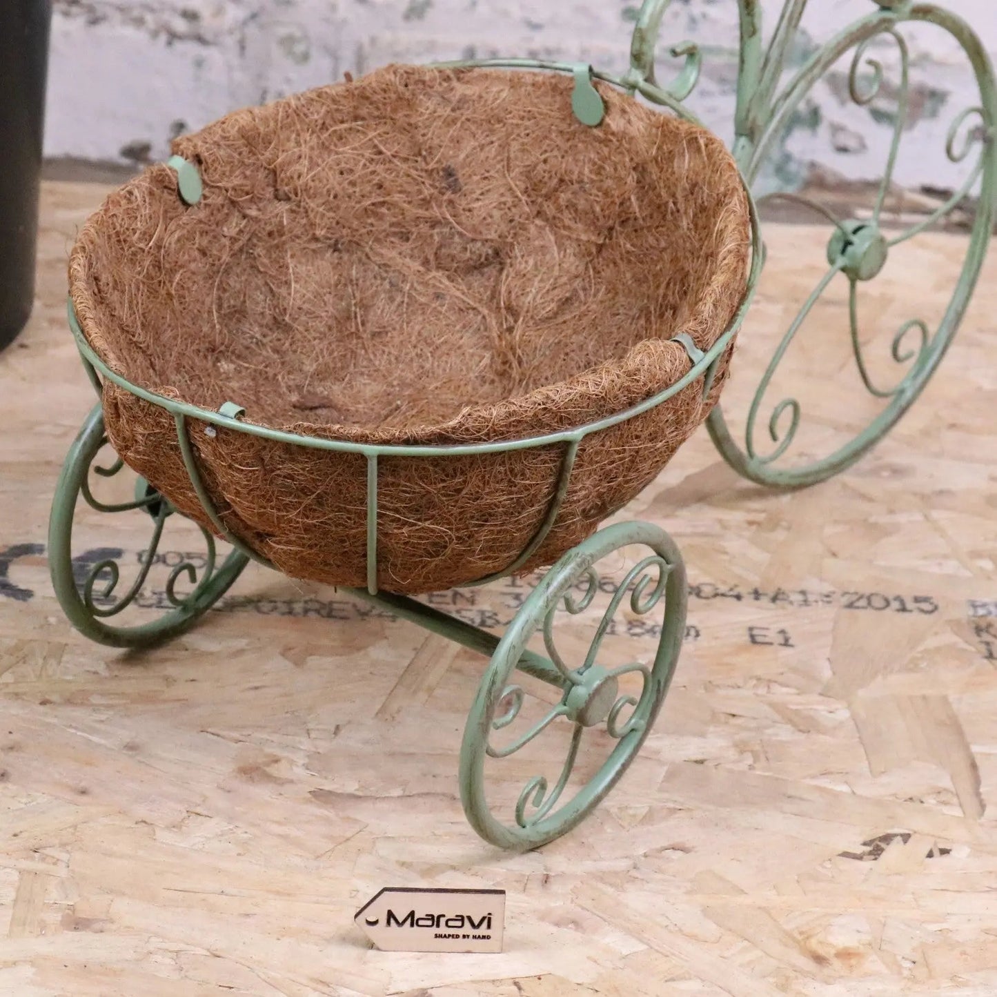 Vintage green metal bike garden planter by Maravi, featuring a charming bike design perfect for outdoor garden decor.