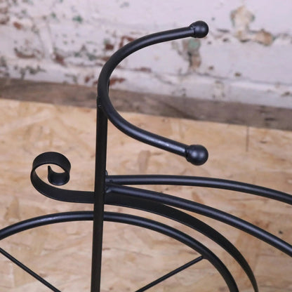 Vintage black metal bike garden planter by Maravi featuring a charming, rustic design for outdoor floral displays.