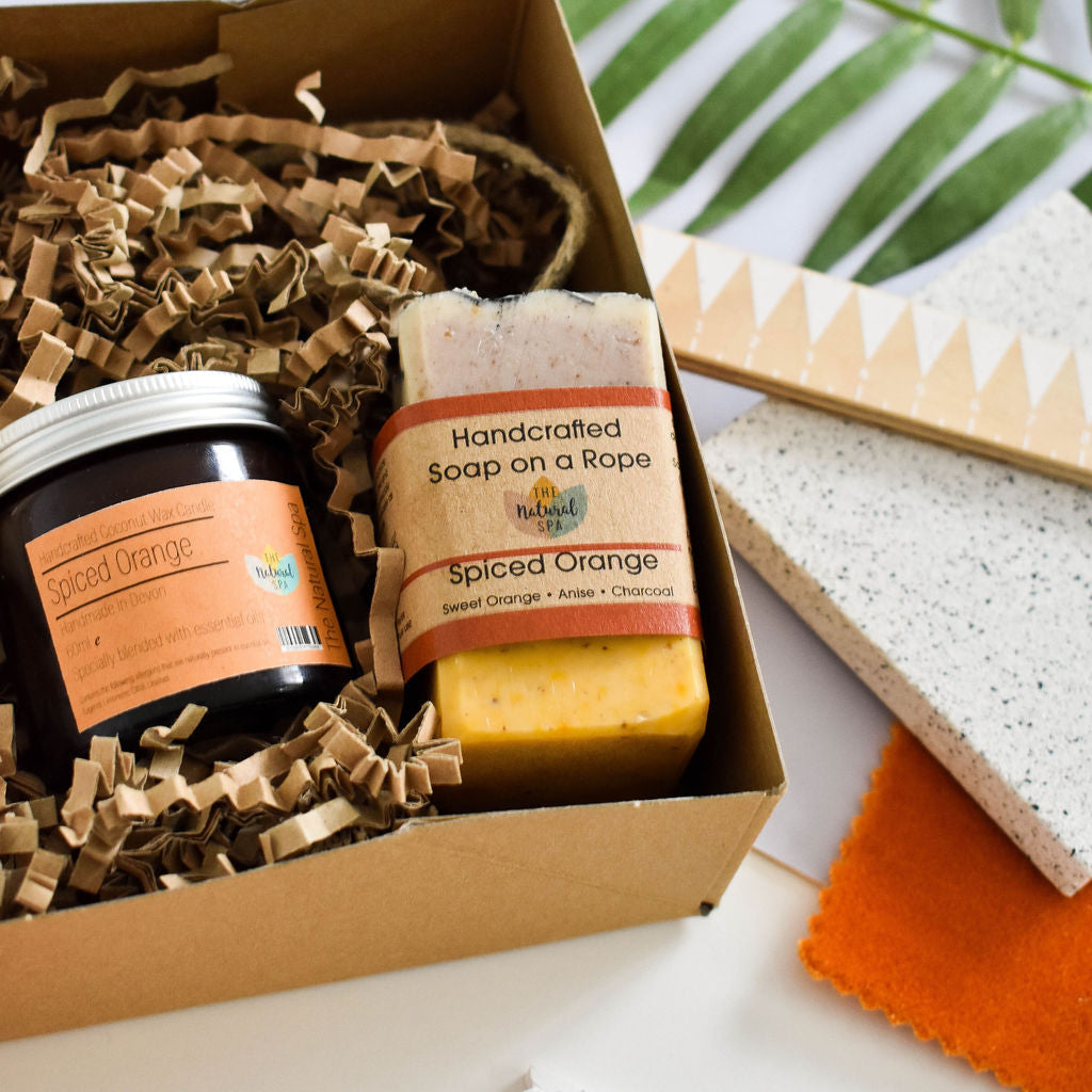 Spiced Orange At Home Natural Spa Set from thenaturalspa with candles, lotions, and spa accessories on a relaxing setup.
