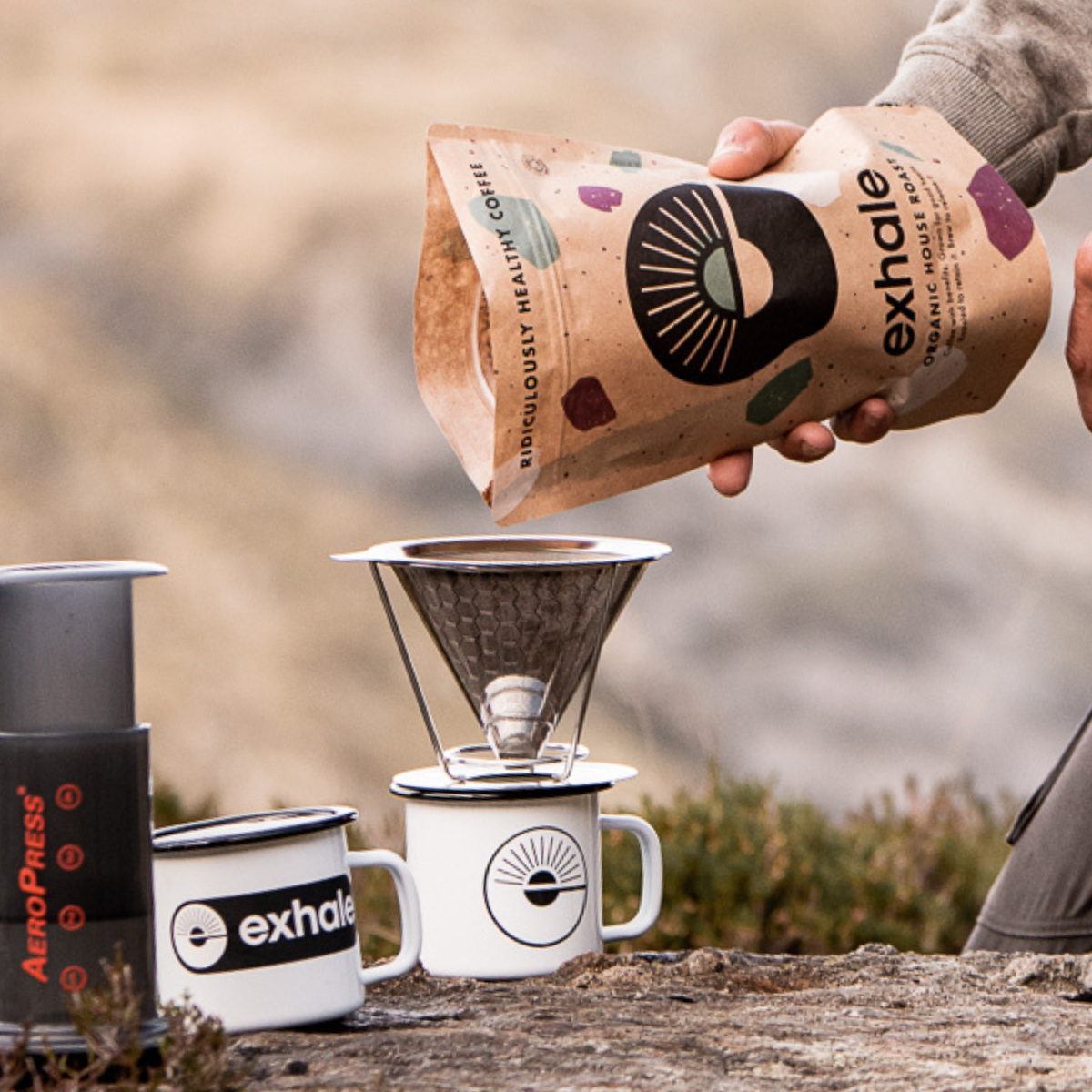 Organic house roast coffee from Exhale Healthy Coffee in a bag, with roasted beans visible and a warm, inviting appearance.