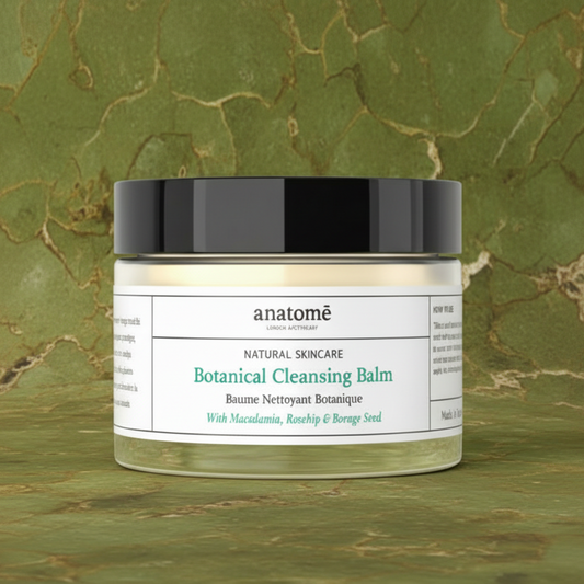 Jar of anatomè Botanical Cleansing Balm on a green marble background