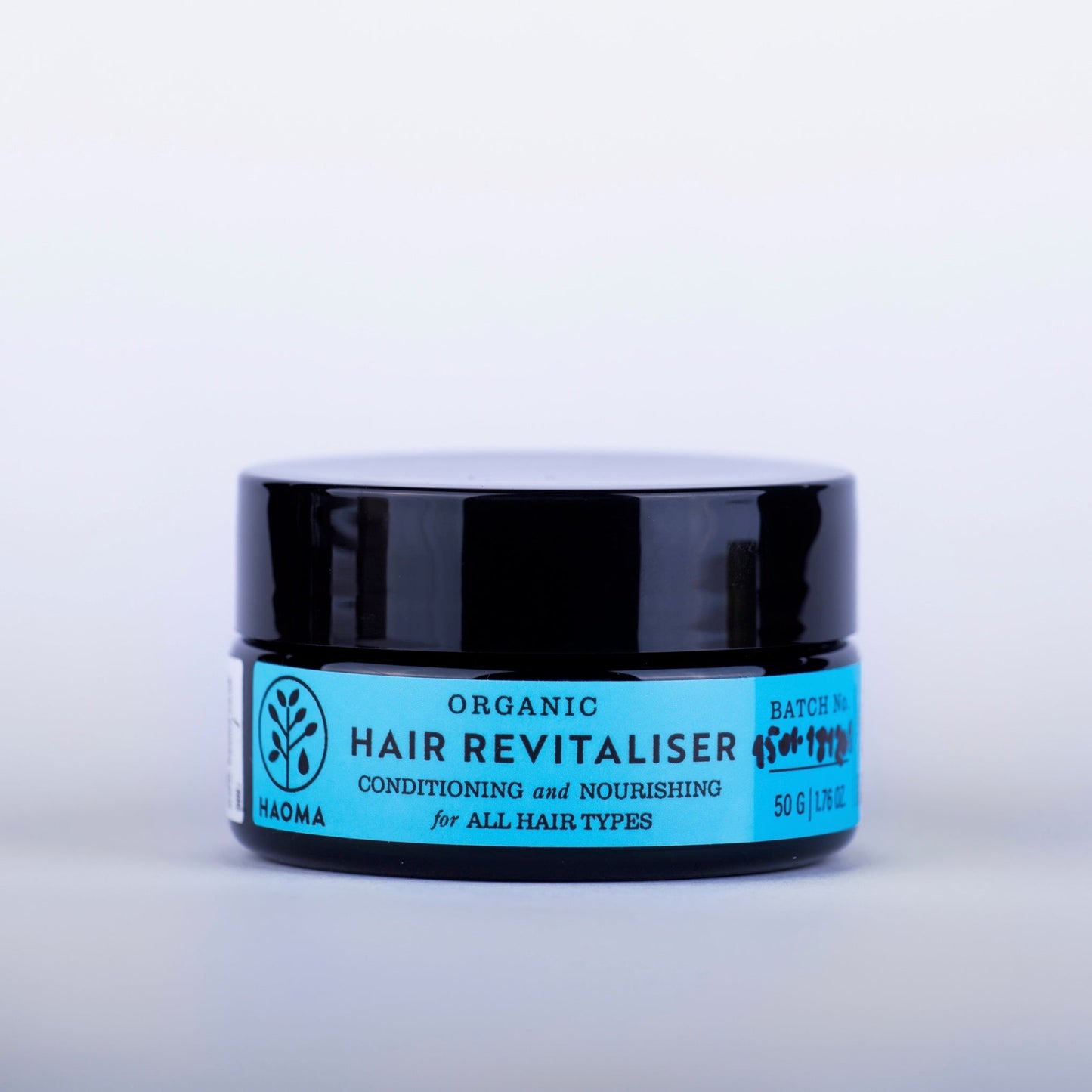 Natural organic hair revitalizer by Haoma with nourishing and strengthening ingredients for healthy, shiny hair.