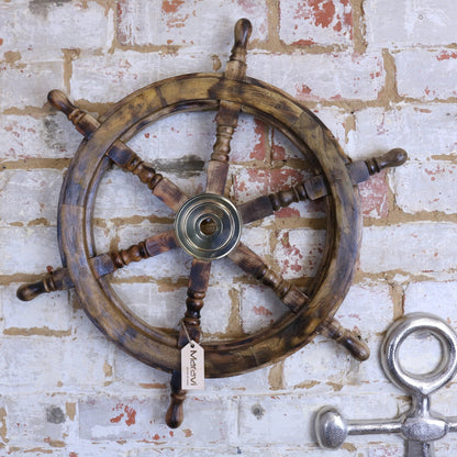 Naav wooden ships wheel ornament in natural color by Maravi, showcasing detailed craftsmanship and nautical design.