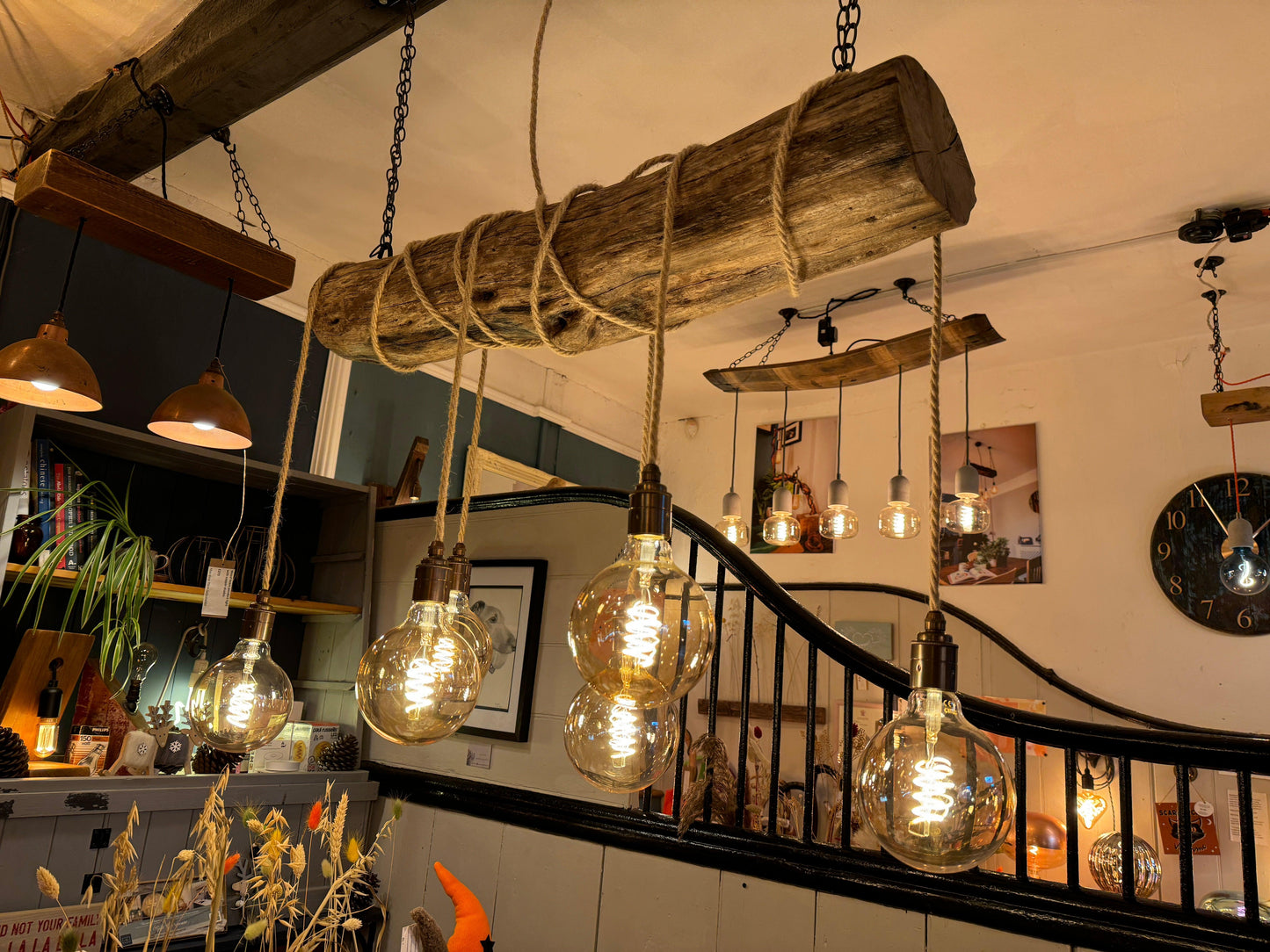 Rustic oak wrap-around chandelier by MooBoo Home with warm wood finish and elegant design hanging from the ceiling.